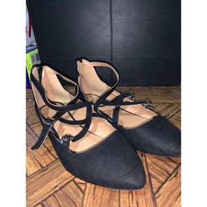 black pointed flats with crisscross detailing